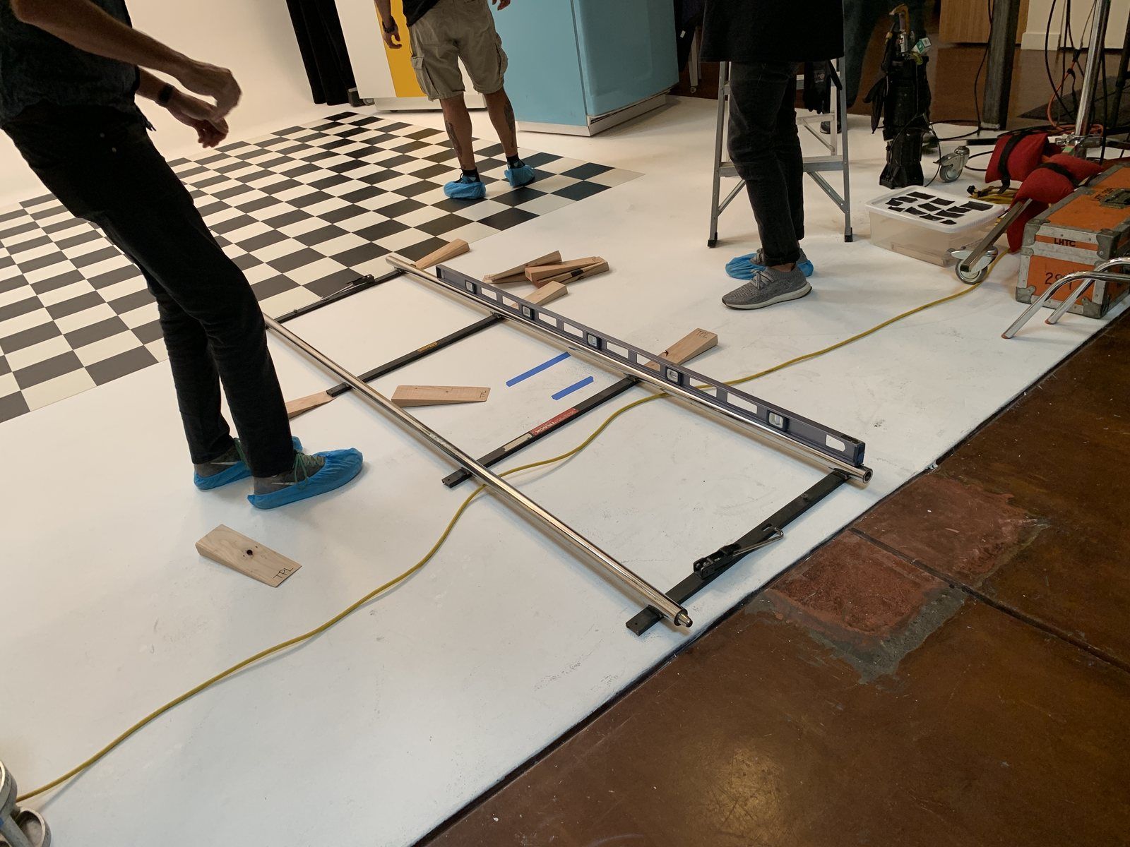 Crew laying and leveling the dolly track on the cyc